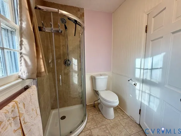 a bathroom with a toilet and a shower