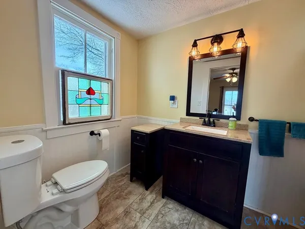 a bathroom with a toilet a sink and a large mirror