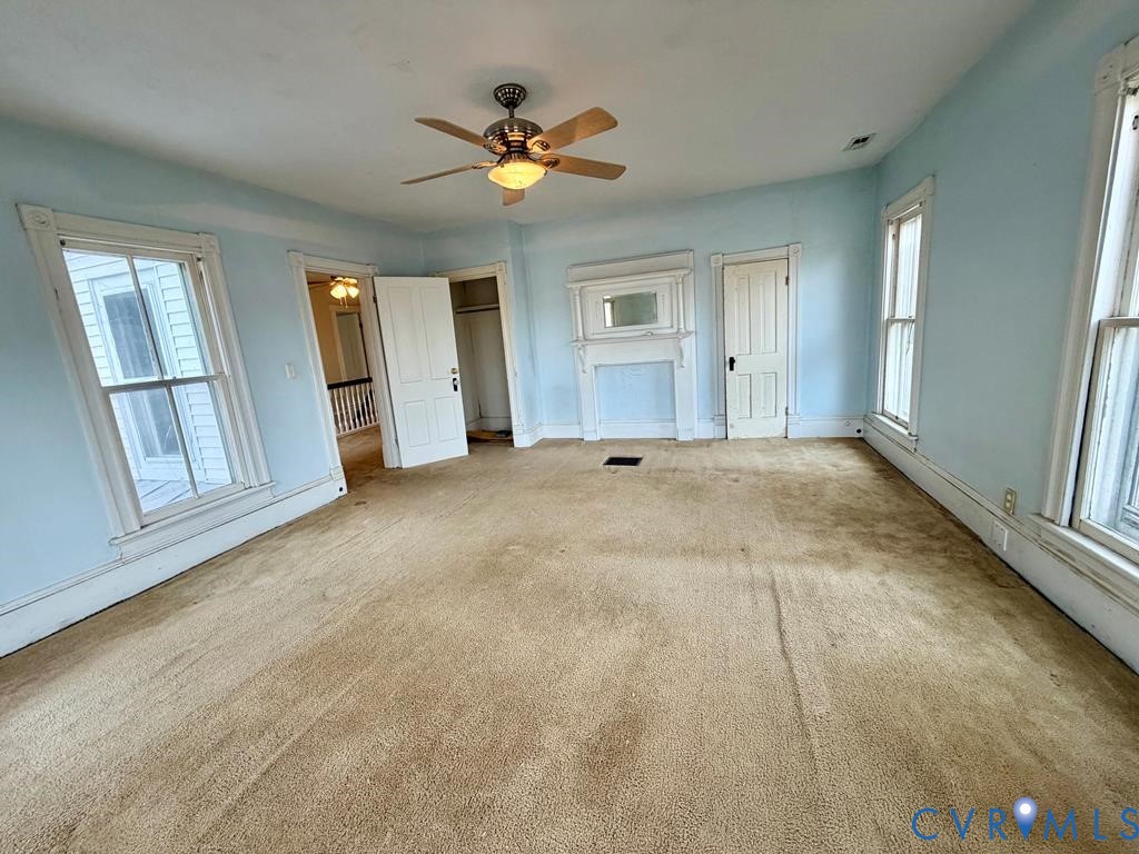 224 Courthouse Road Heathsville, VA 22473 - Photo 27 of 37 an empty room with windows and ceiling fan