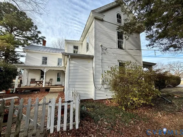 a front view of house with yard and trees around