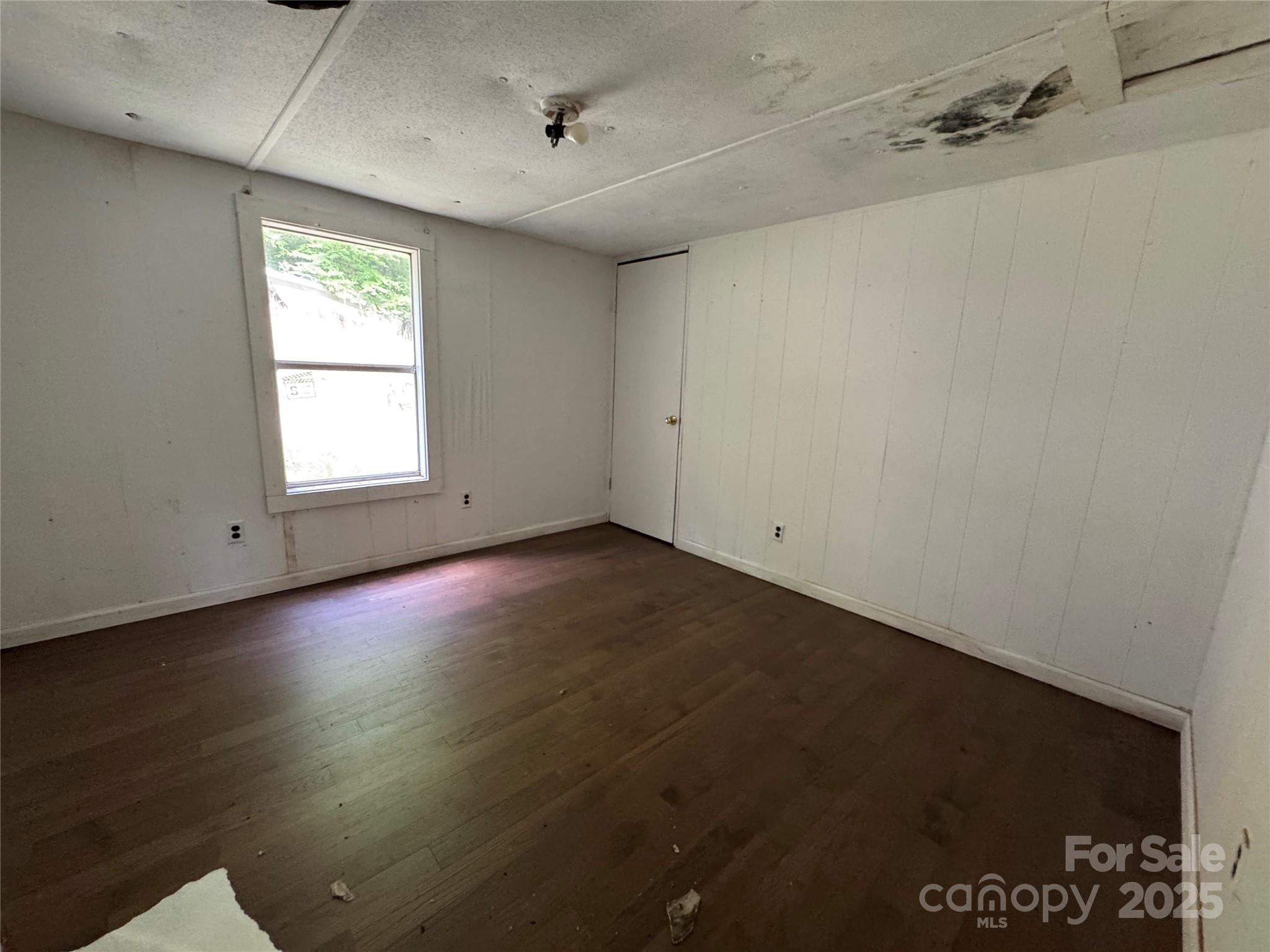 91 Keys Hill Road Almond, NC 28702 - Photo 19 of 19 an empty room with wooden floor and windows