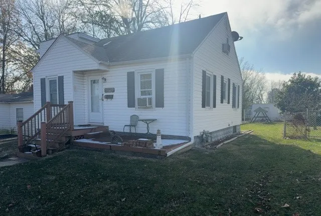 a backyard of a house with table and chairs