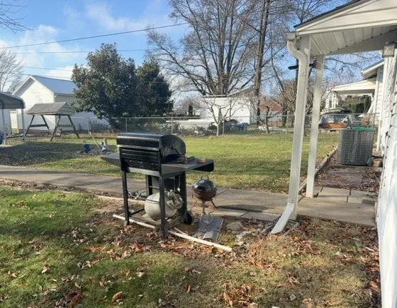 a view of a garden with a bench and fire pit