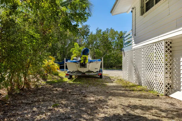 a view of wooden house with a small yard
