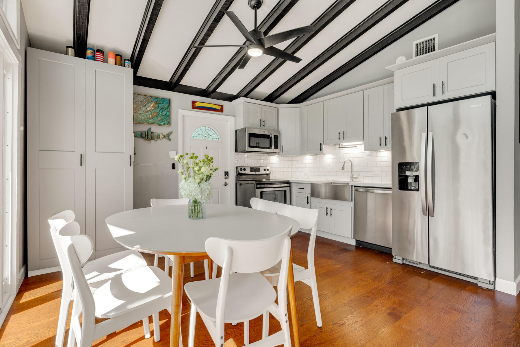 29961 Pine Channel Road Big Pine Key, FL 33043 - Photo 7 of 32 a kitchen with stainless steel appliances granite countertop a dining table chairs refrigerator and a stove