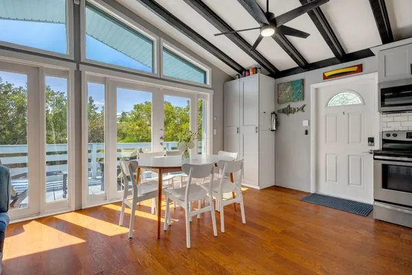 a kitchen with stainless steel appliances granite countertop a sink dishwasher a refrigerator with wooden cabinets and floor