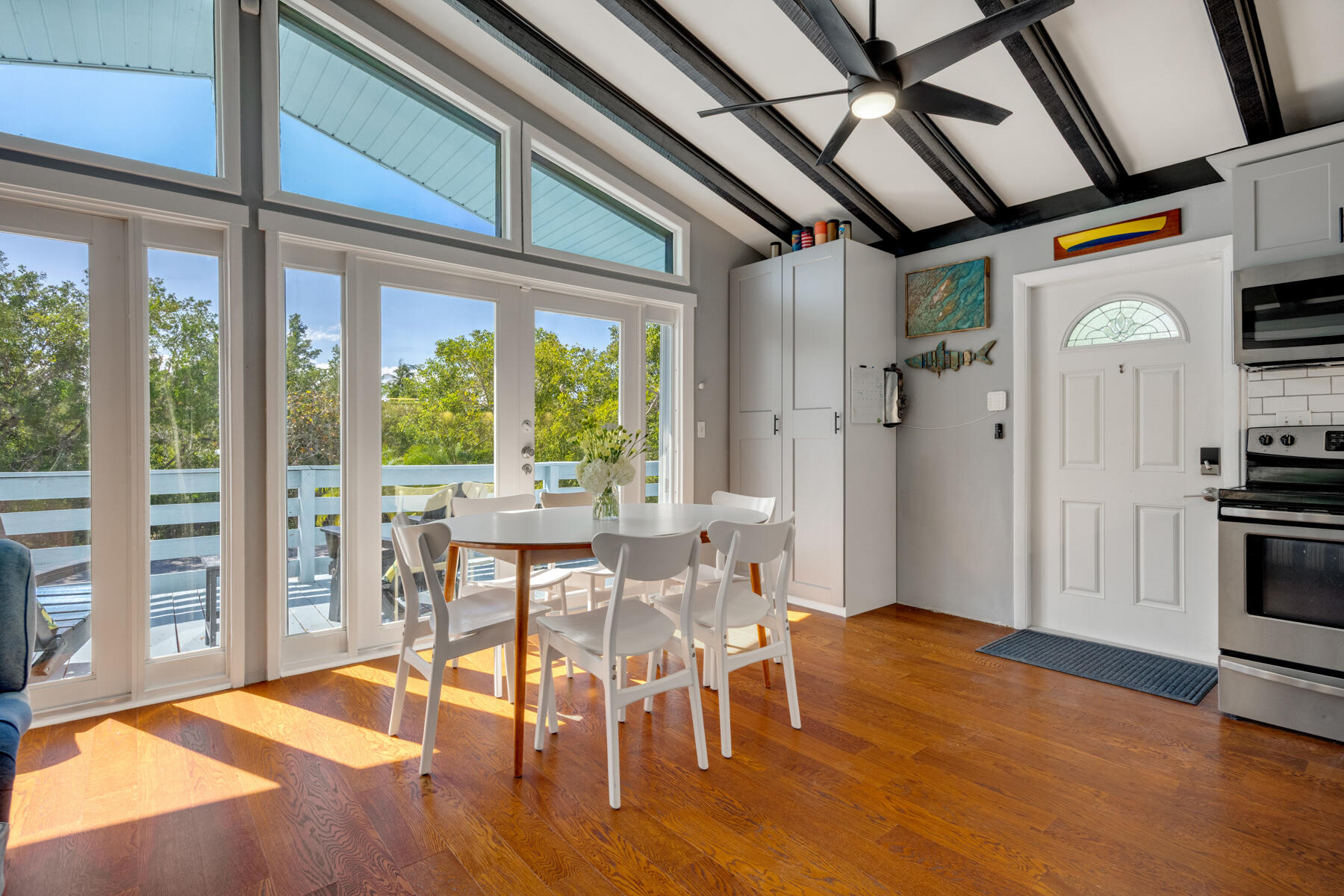 29961 Pine Channel Road Big Pine Key, FL 33043 - Photo 8 of 32 a view of a dining room with furniture window and wooden floor