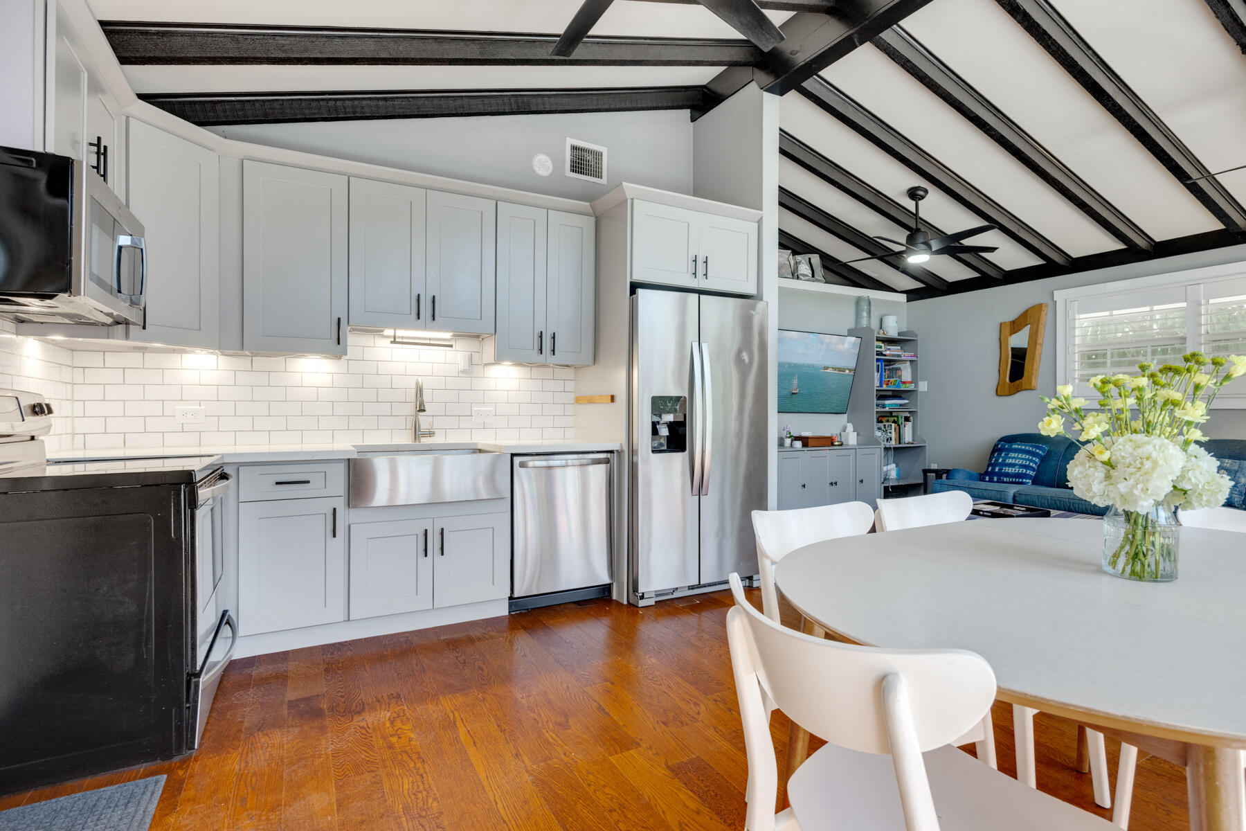 29961 Pine Channel Road Big Pine Key, FL 33043 - Photo 9 of 32 a kitchen with stainless steel appliances granite countertop a sink dishwasher a refrigerator with wooden cabinets and floor