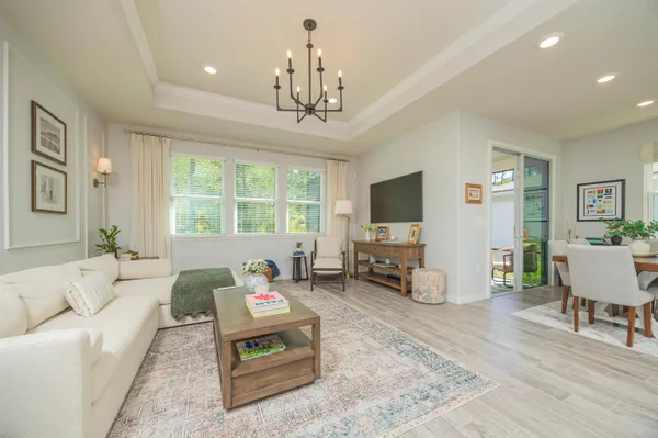 a living room with furniture and a chandelier