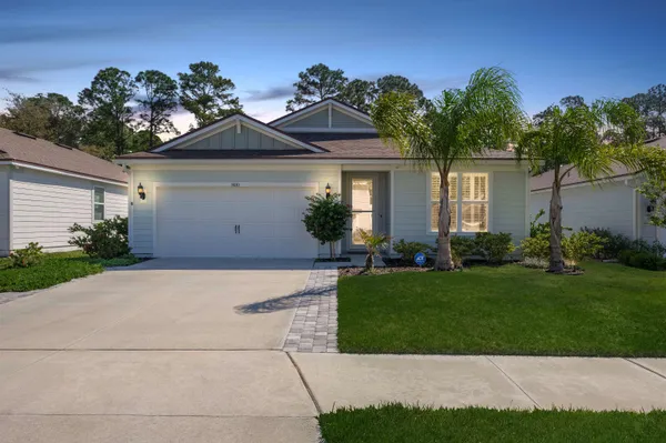a front view of a house with a garden and plants