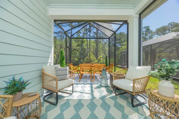 a front view of a house with a yard and palm trees
