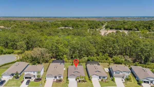 a view of a house with a yard and sitting area