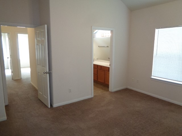 205 Maple Lane Conroe, TX 77304 - Photo 11 of 19 an empty room with windows and entrance