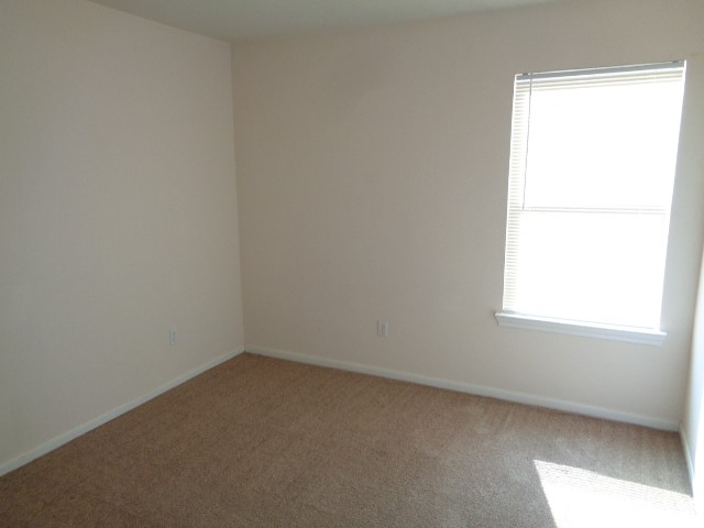 205 Maple Lane Conroe, TX 77304 - Photo 12 of 19 an empty room with a window