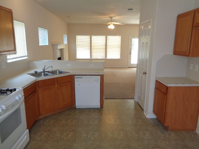205 Maple Lane Conroe, TX 77304 - Photo 6 of 19 a bathroom with a granite countertop sink a mirror and a shower