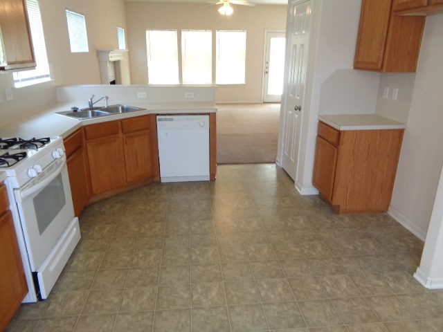 205 Maple Lane Conroe, TX 77304 - Photo 8 of 19 a kitchen with stainless steel appliances granite countertop a sink stove and refrigerator