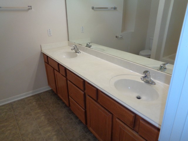 205 Maple Lane Conroe, TX 77304 - Photo 9 of 19 a bathroom with a double vanity sink and large mirror