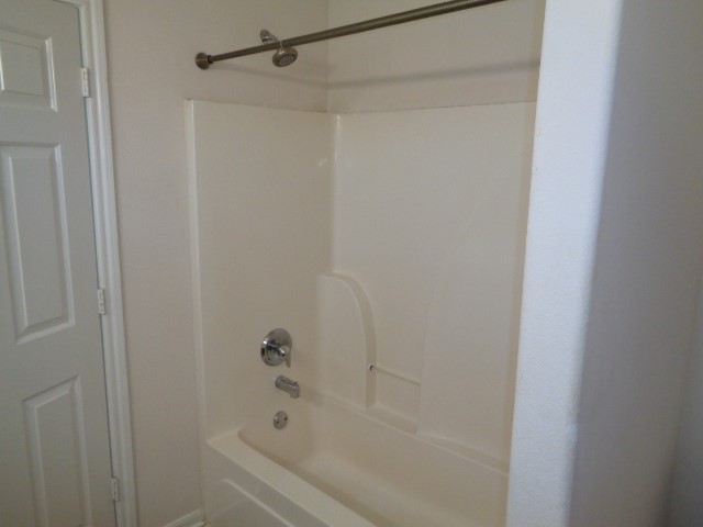 205 Maple Lane Conroe, TX 77304 - Photo 10 of 19 a bathroom with a bathtub