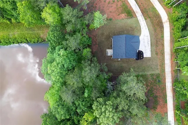 an aerial view of a house with pool outdoor seating and yard