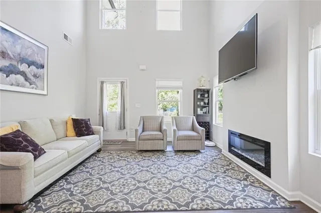 a living room with furniture wooden floor and a flat screen tv