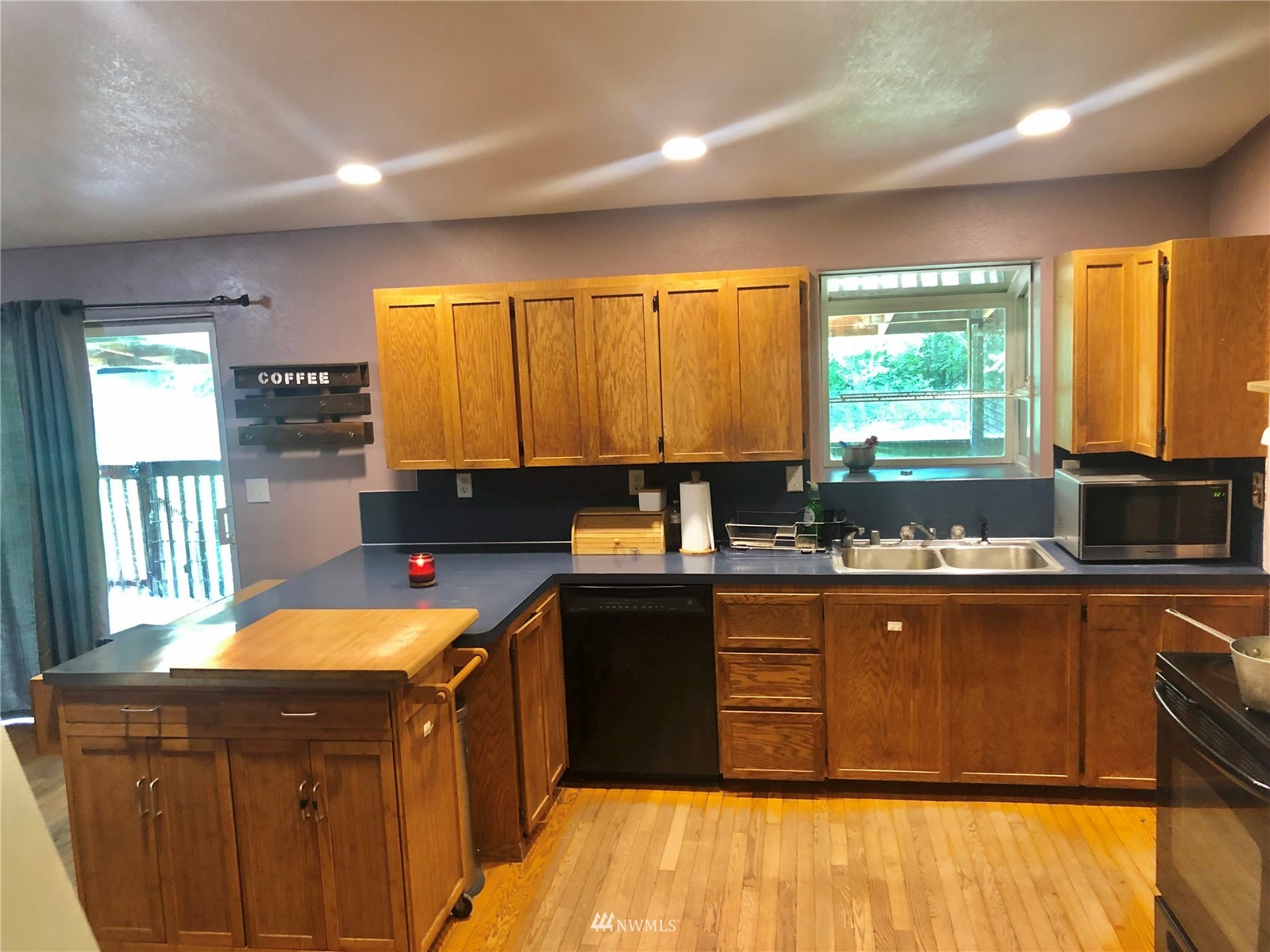 144 Morgan Road Toutle, WA 98649 - Photo 19 of 40 a kitchen with a sink a counter top space a large window and cabinets