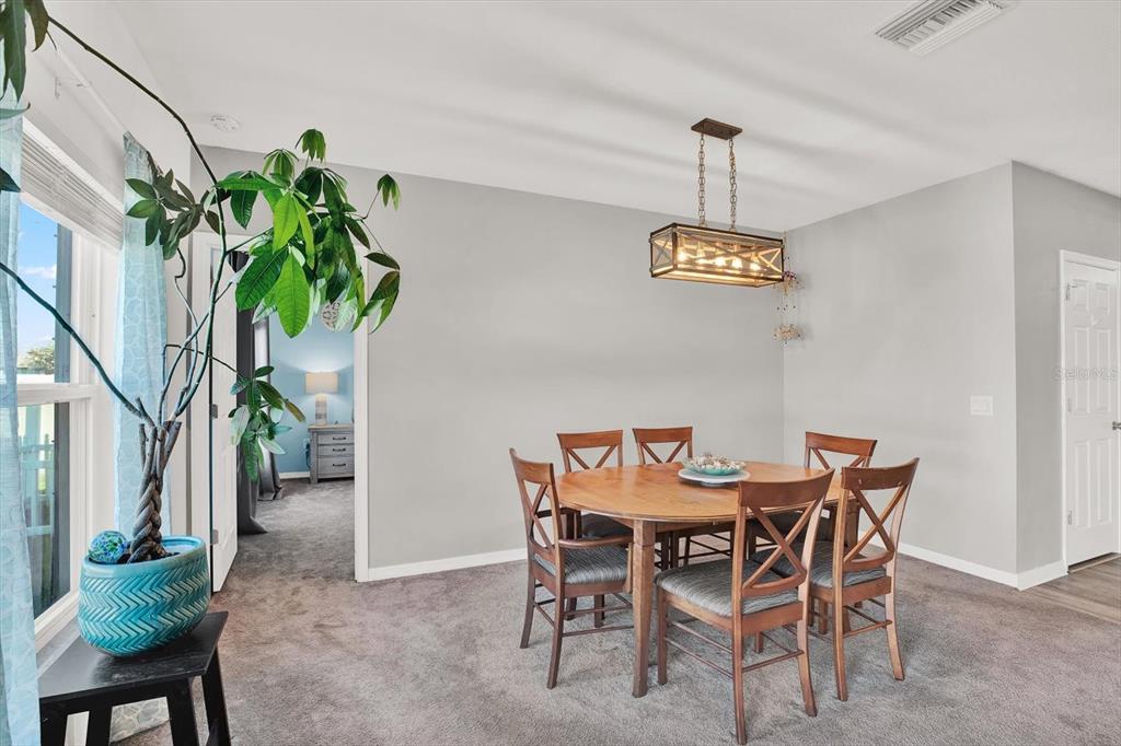 12103 Gothic Rd Spring Hill Spring Hill, FL 34610 - Photo 12 of 44 a dining room filled with furniture and a chandelier
