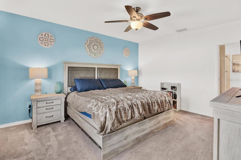 12103 Gothic Rd Spring Hill Spring Hill, FL 34610 - Photo 13 of 44 a bedroom with a bed and a chandelier