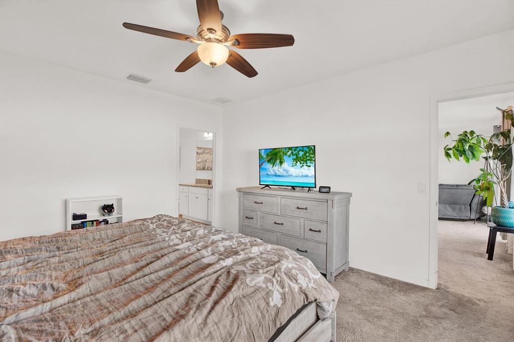 12103 Gothic Rd Spring Hill Spring Hill, FL 34610 - Photo 15 of 44 a bedroom with a bed and a dresser