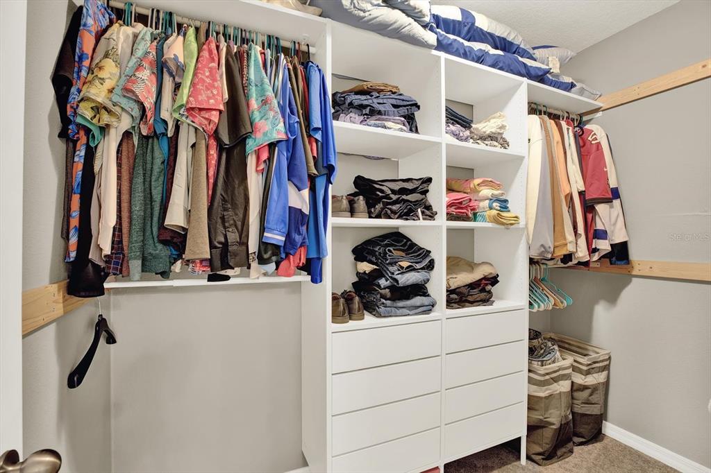 12103 Gothic Rd Spring Hill Spring Hill, FL 34610 - Photo 17 of 44 a view of walk in closet with clothes and shoes