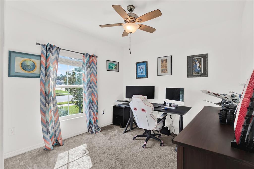 12103 Gothic Rd Spring Hill Spring Hill, FL 34610 - Photo 20 of 44 a view of a workspace with furniture and a window