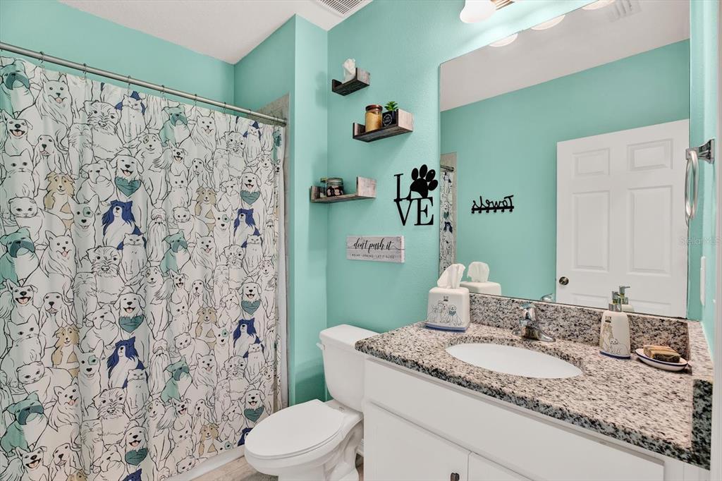 12103 Gothic Rd Spring Hill Spring Hill, FL 34610 - Photo 22 of 44 a bathroom with a granite countertop sink and a mirror