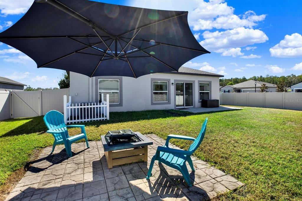 12103 Gothic Rd Spring Hill Spring Hill, FL 34610 - Photo 26 of 44 a patio with table and chairs