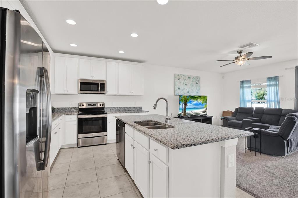 12103 Gothic Rd Spring Hill Spring Hill, FL 34610 - Photo 4 of 44 a kitchen with stainless steel appliances granite countertop a sink stove and refrigerator