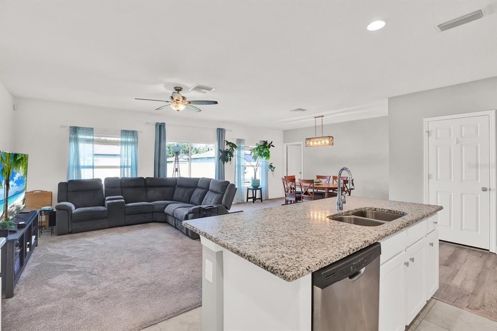 12103 Gothic Rd Spring Hill Spring Hill, FL 34610 - Photo 6 of 44 a living room with granite countertop furniture a fireplace and a potted plant
