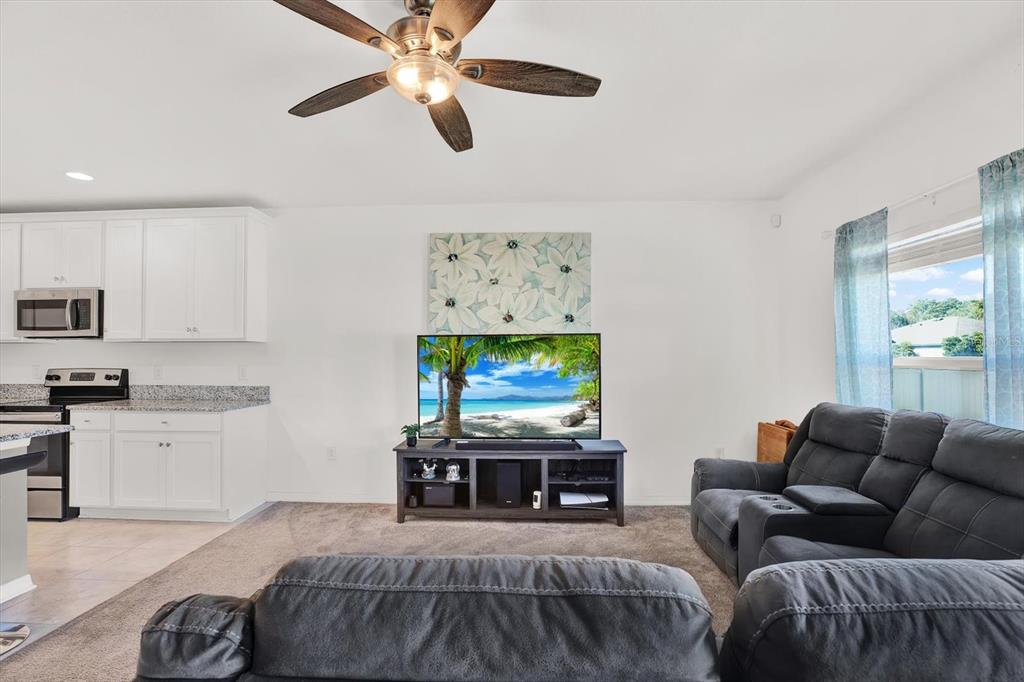12103 Gothic Rd Spring Hill Spring Hill, FL 34610 - Photo 8 of 44 a living room with furniture and a flat screen tv