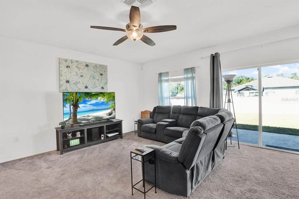 12103 Gothic Rd Spring Hill Spring Hill, FL 34610 - Photo 9 of 44 a living room with furniture a flat screen tv and a window