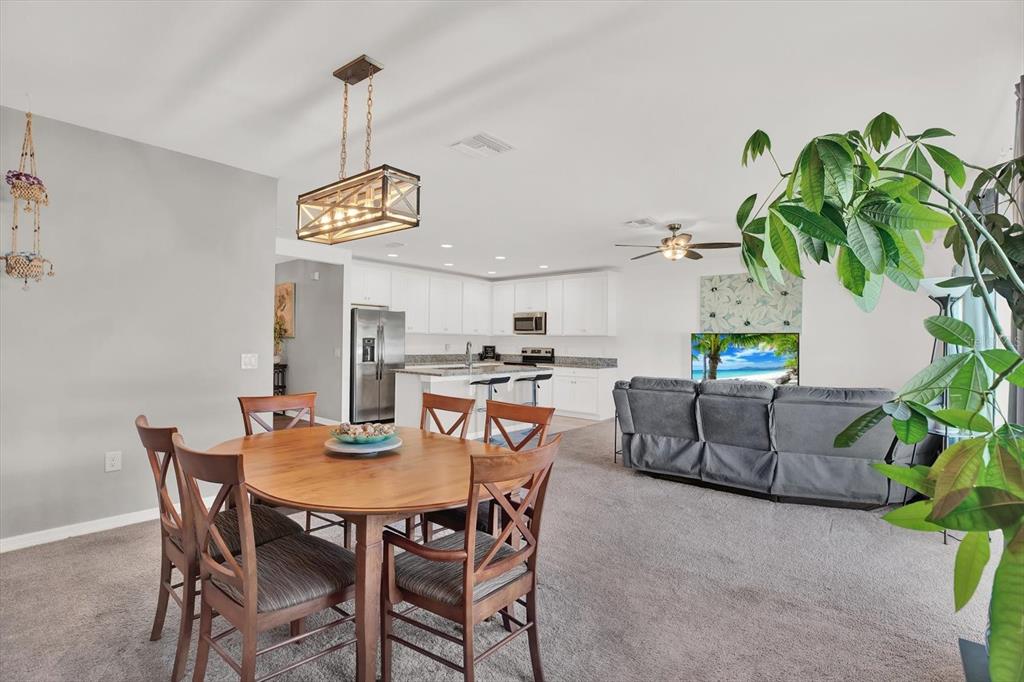 12103 Gothic Rd Spring Hill Spring Hill, FL 34610 - Photo 10 of 44 a view of a dining room and kitchen with furniture and a potted plant