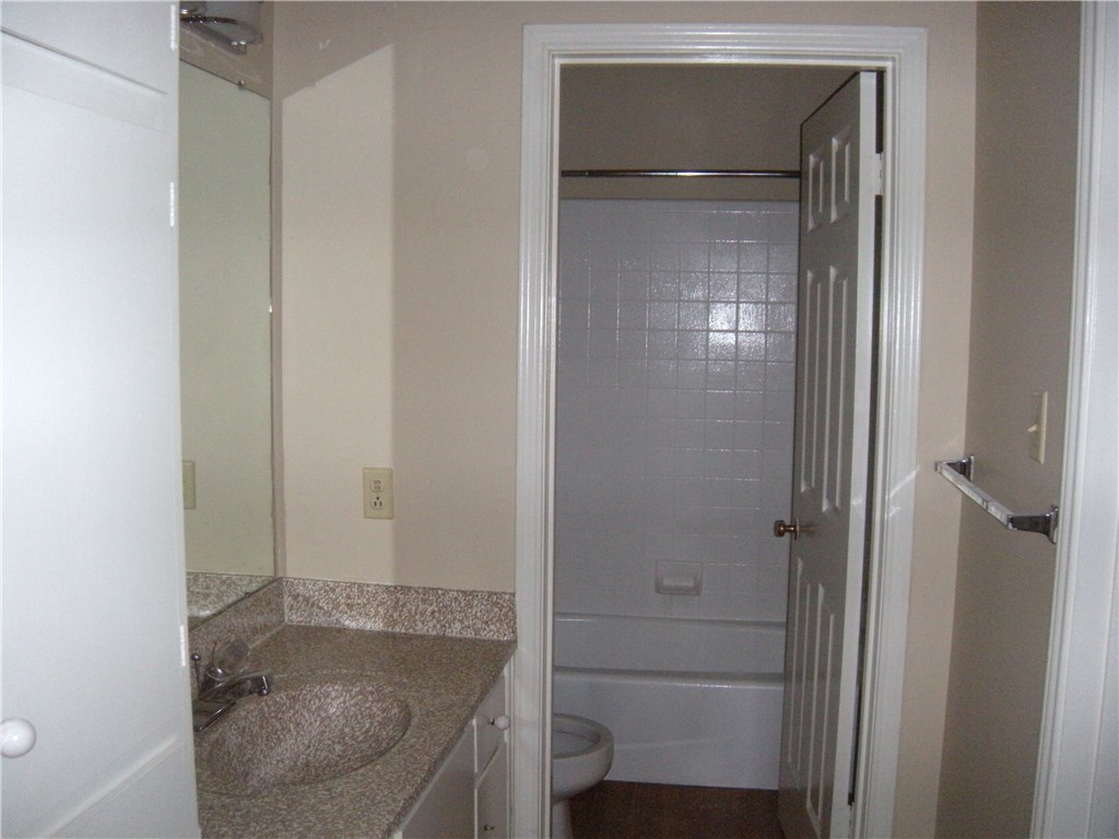 2529 Rio Grande Street, Unit 57 Austin, TX 78705 - Photo 11 of 20 a bathroom with a granite countertop sink and mirror