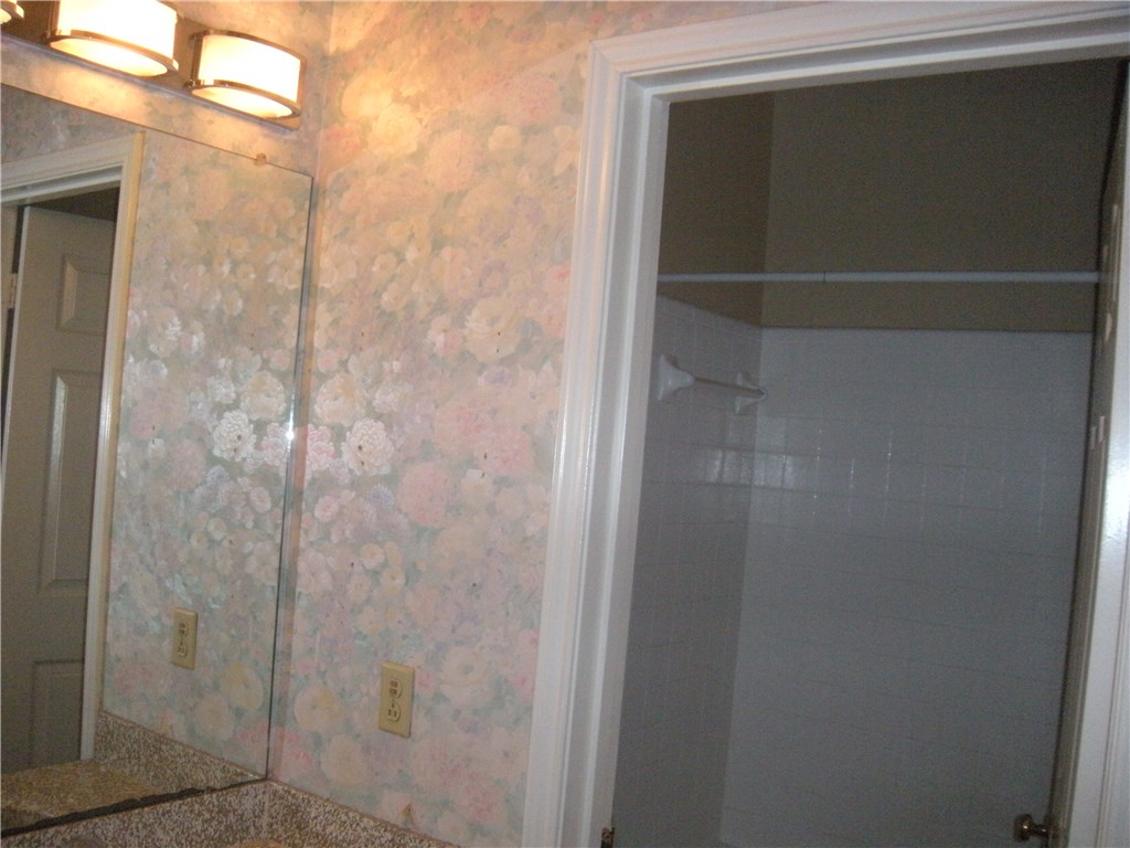 2529 Rio Grande Street, Unit 57 Austin, TX 78705 - Photo 16 of 20 a bathroom with a glass shower door