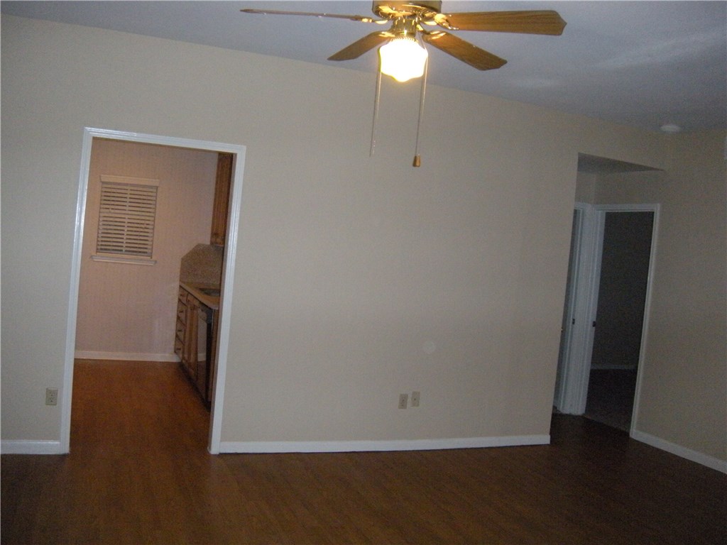 2529 Rio Grande Street, Unit 57 Austin, TX 78705 - Photo 4 of 20 an empty room with wooden floor and fan