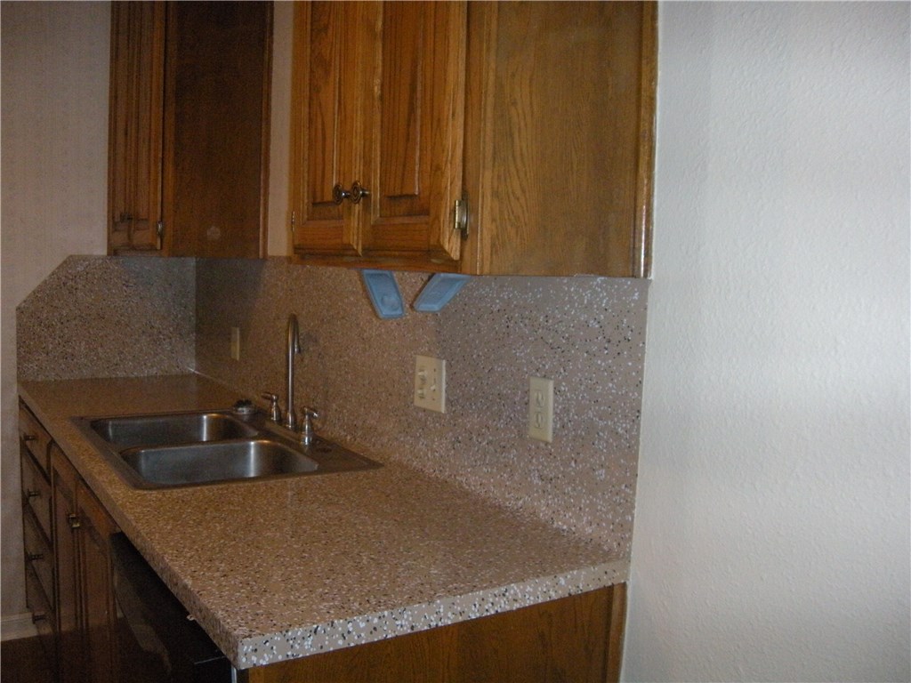 2529 Rio Grande Street, Unit 57 Austin, TX 78705 - Photo 7 of 20 a bathroom with a granite countertop sink and mirror
