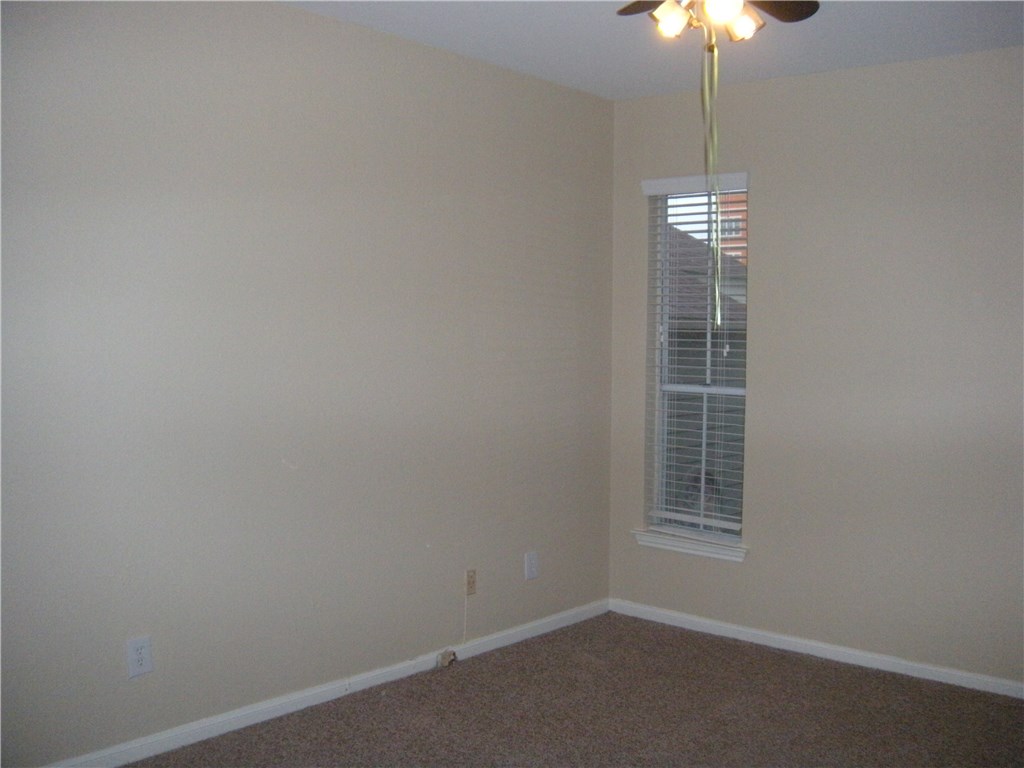 2529 Rio Grande Street, Unit 57 Austin, TX 78705 - Photo 8 of 20 an empty room with windows and chandelier fan