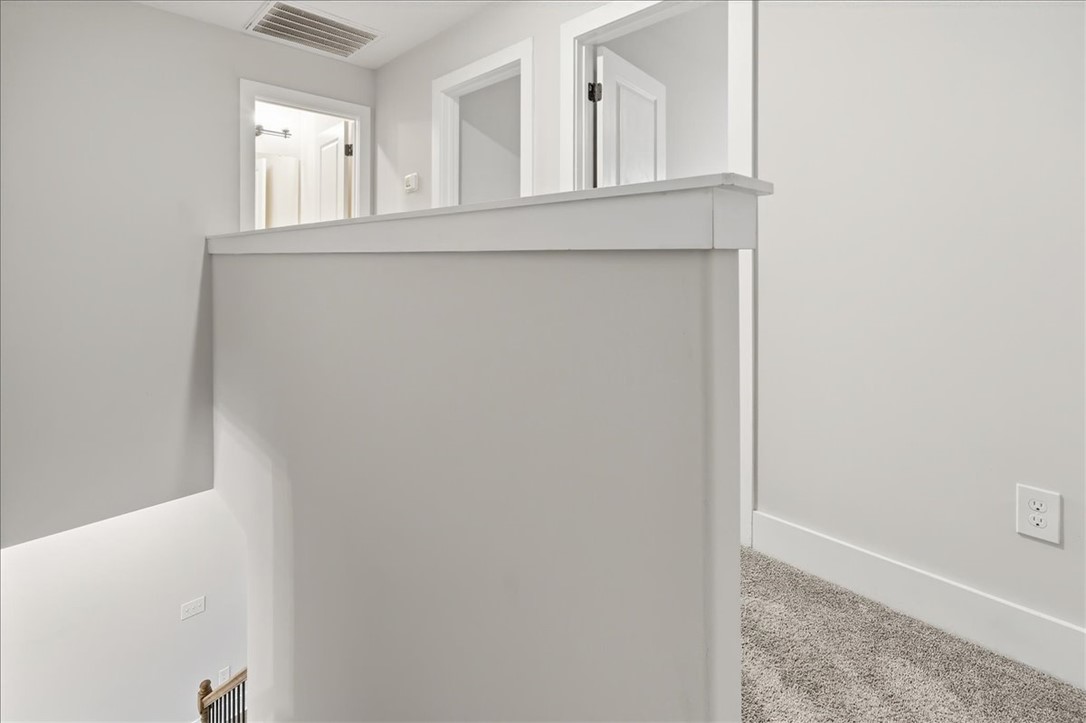 427 Bee Cv Way Pendleton, SC 29670 - Photo 23 of 32 A well-lit upper landing features durable carpet flooring and crisp white trim.