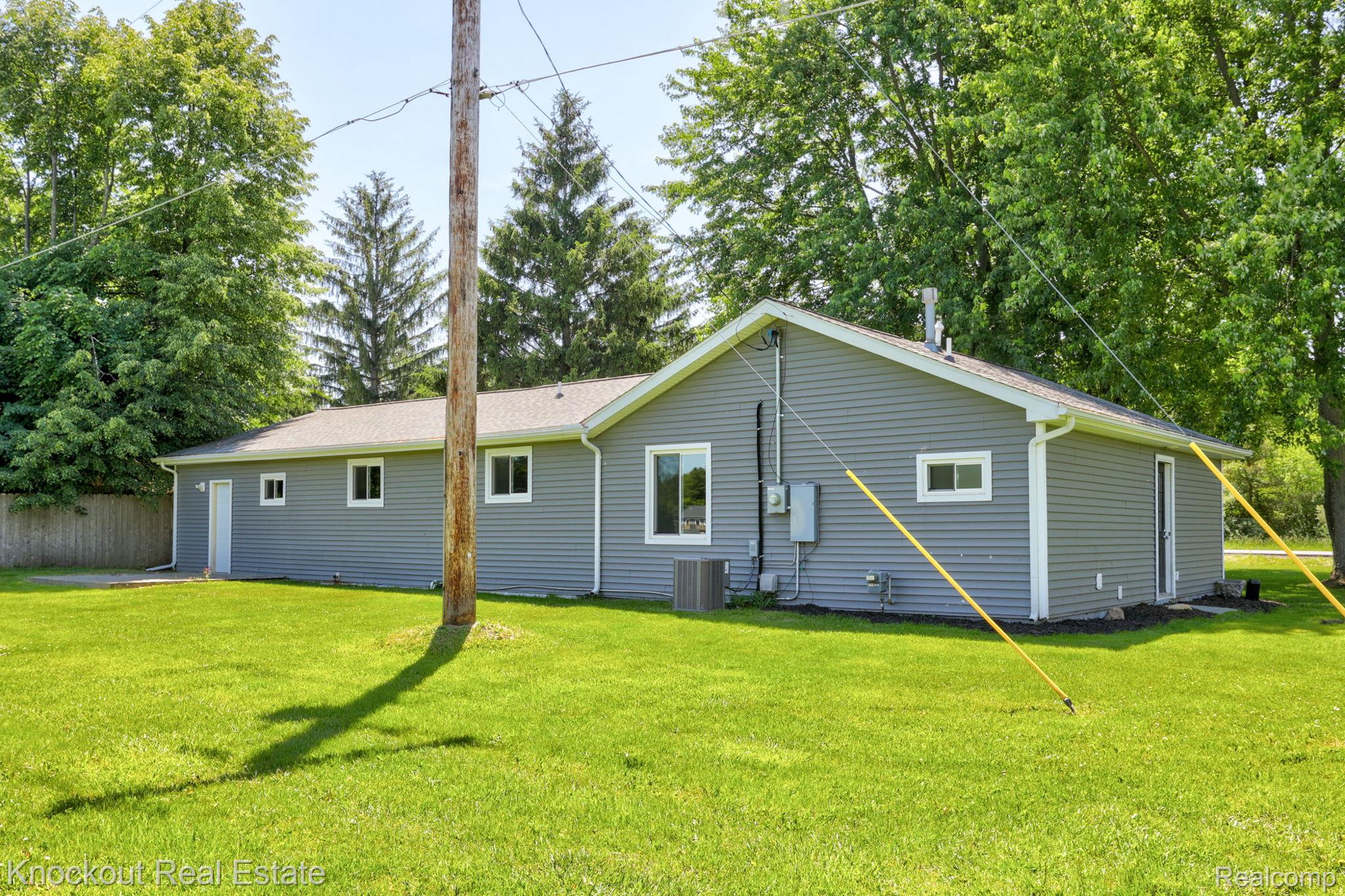 8845 Ormes Road Vassar, MI 48768 - Photo 28 of 35 Gray siding exterior with white trim windows and a light gray shingle roof