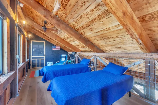 a view of balcony with wooden floor and fence