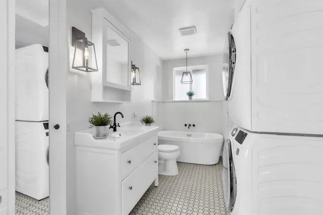 a view of a patio with a dining table and chairs under an umbrella