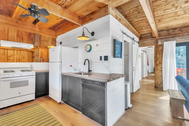 a view of a hallway with a white walls and stairs