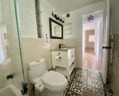 a view of a bedroom with stairs and wooden floor