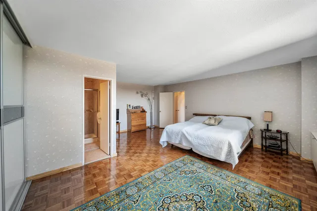 a bedroom with a bed and a table