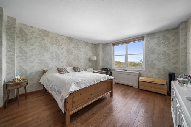 a bedroom with a bed and a desk